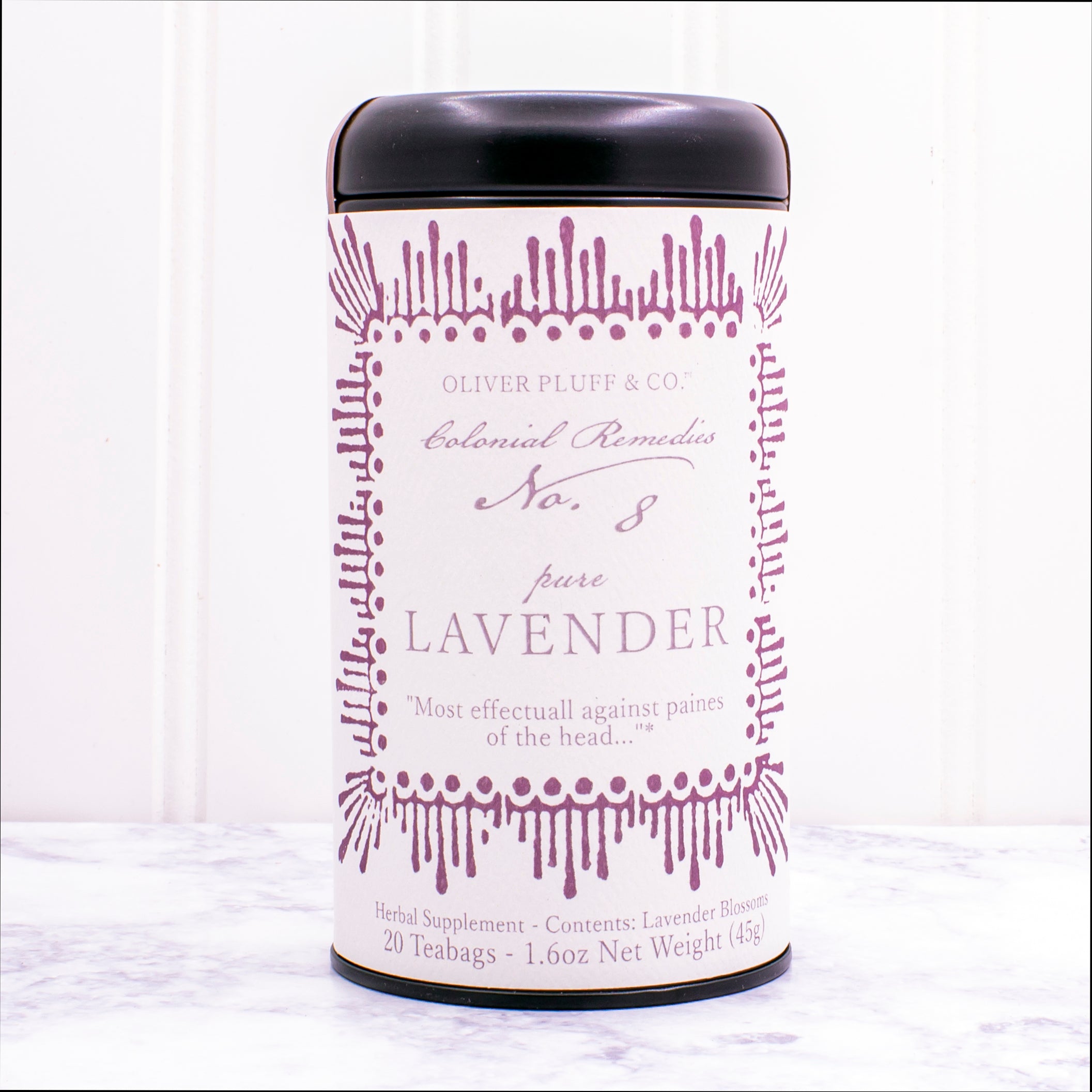 A matte black tin containing 20 biodegradable teabags of No. 8 Pure Lavender tea, showcasing lavender blossoms.