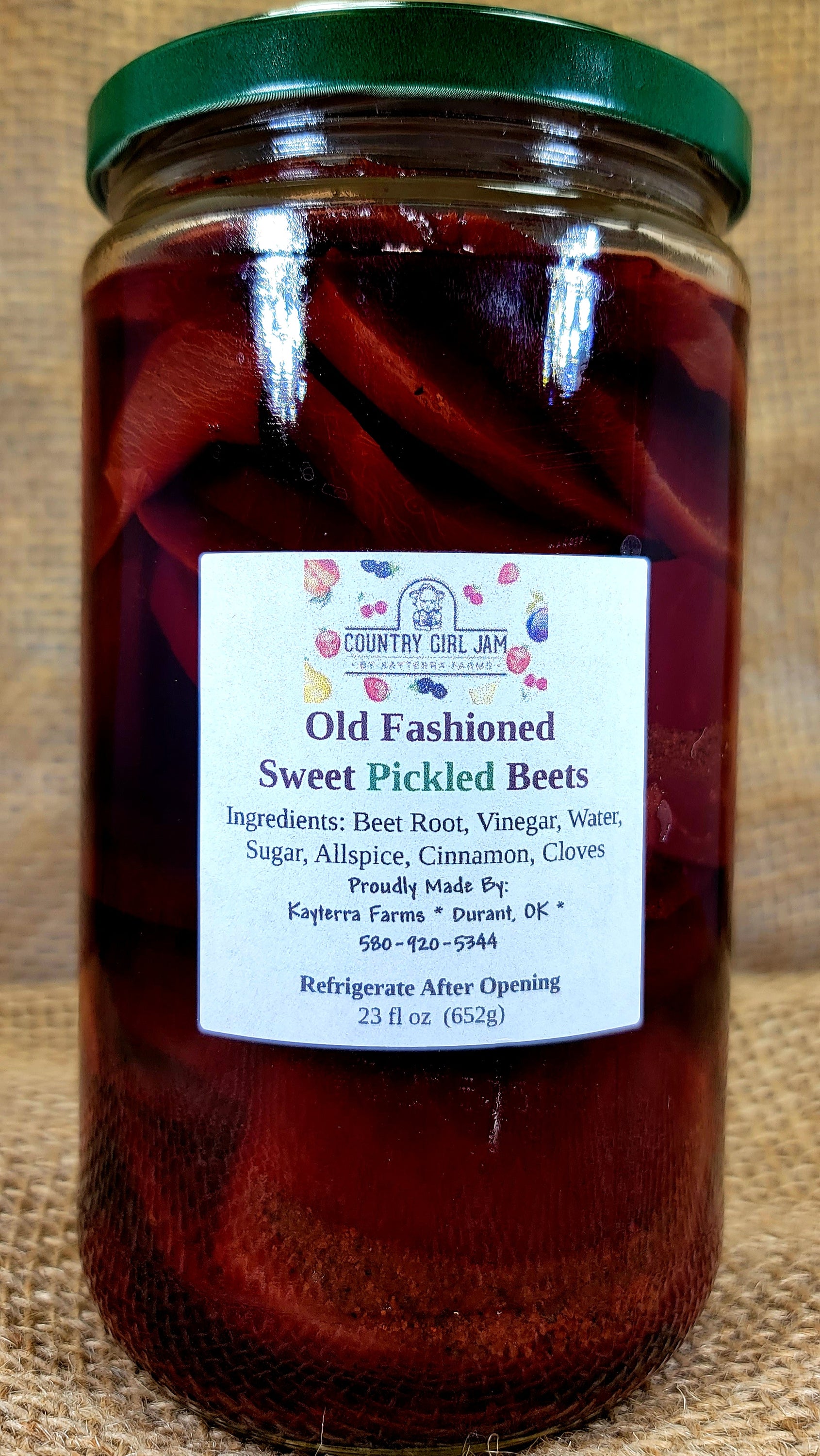 A jar of Old Fashioned Sweet Pickled Beets, showcasing vibrant red beets in a sweet brine with spices.