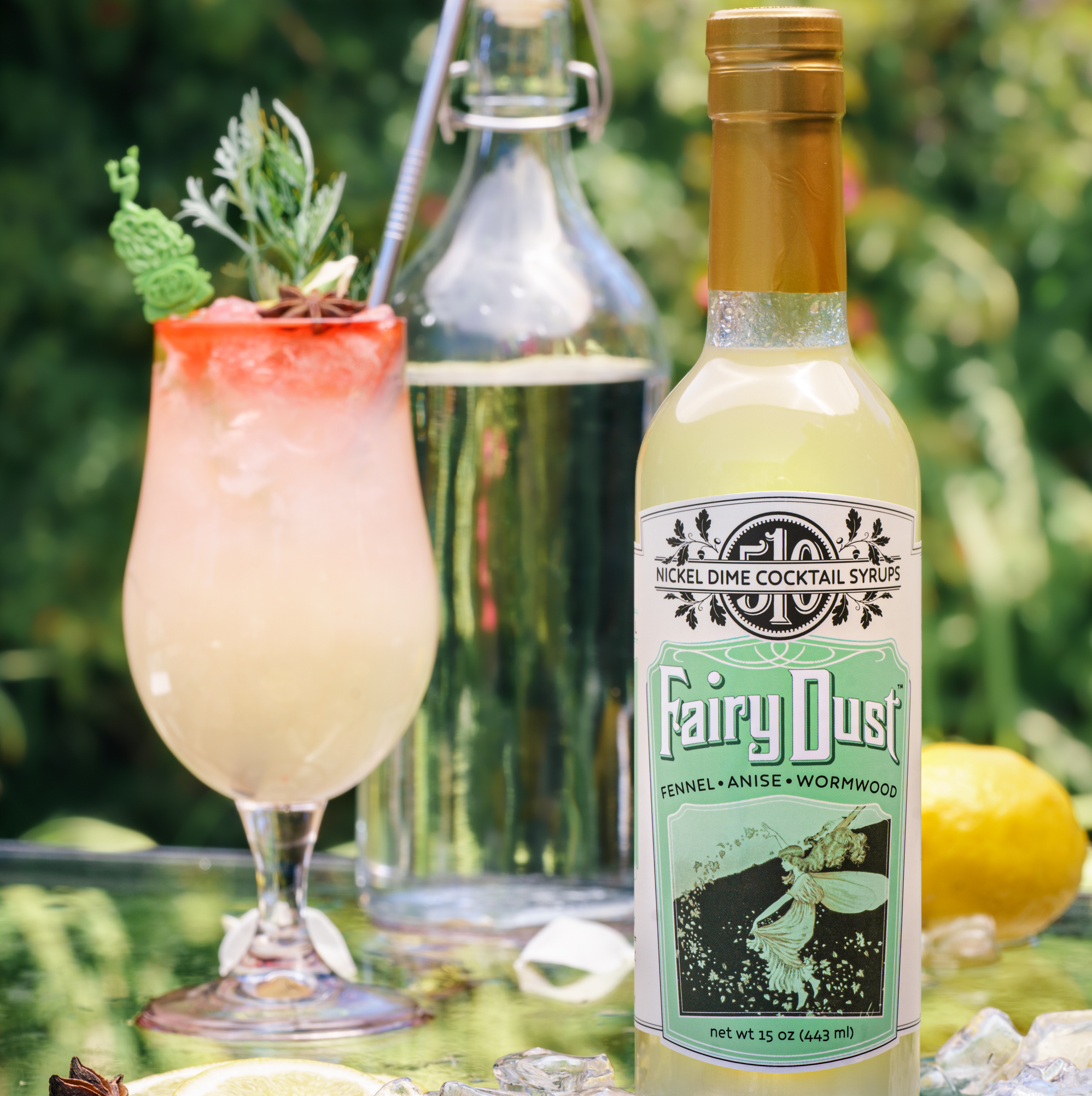 One Case Fairy Dust cocktail syrup featuring fennel, anise, and wormwood in elegant glass bottles.