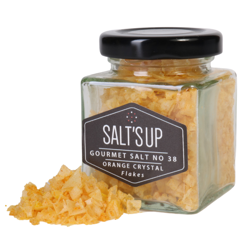 A glass jar of ORANGE salt flakes, showcasing the vibrant orange color and crunchy texture of the salt.