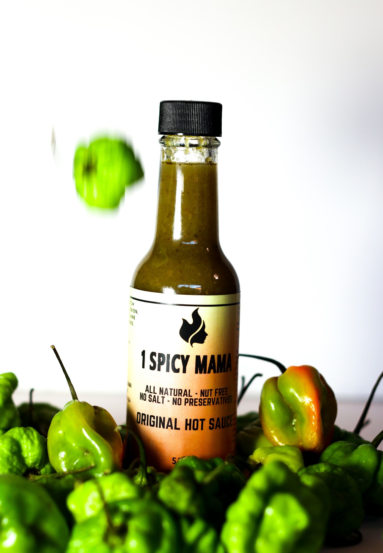 Bottle of Original Hot Sauce made from scotch bonnet peppers, showcasing its vibrant color and natural ingredients.