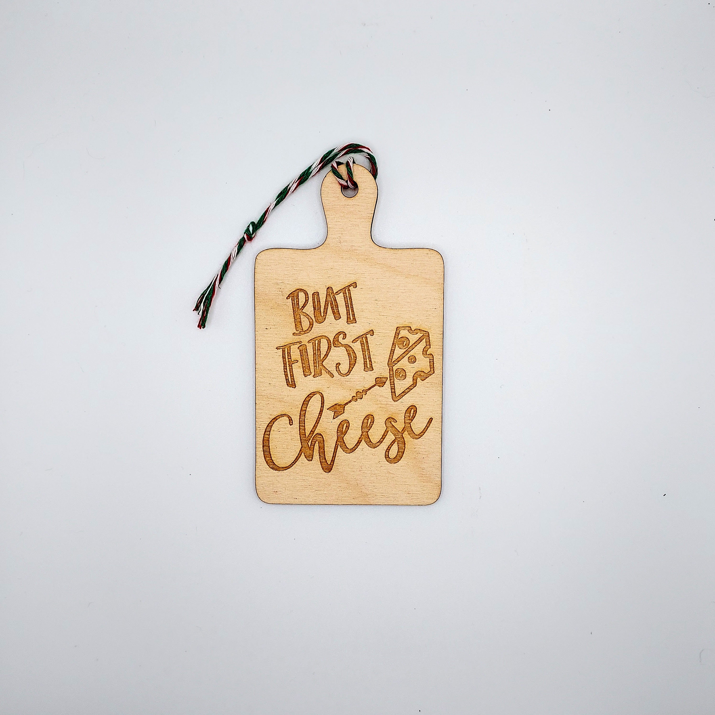 A charming wooden ornament featuring whimsical cheese-themed quotes, perfect for home decor.