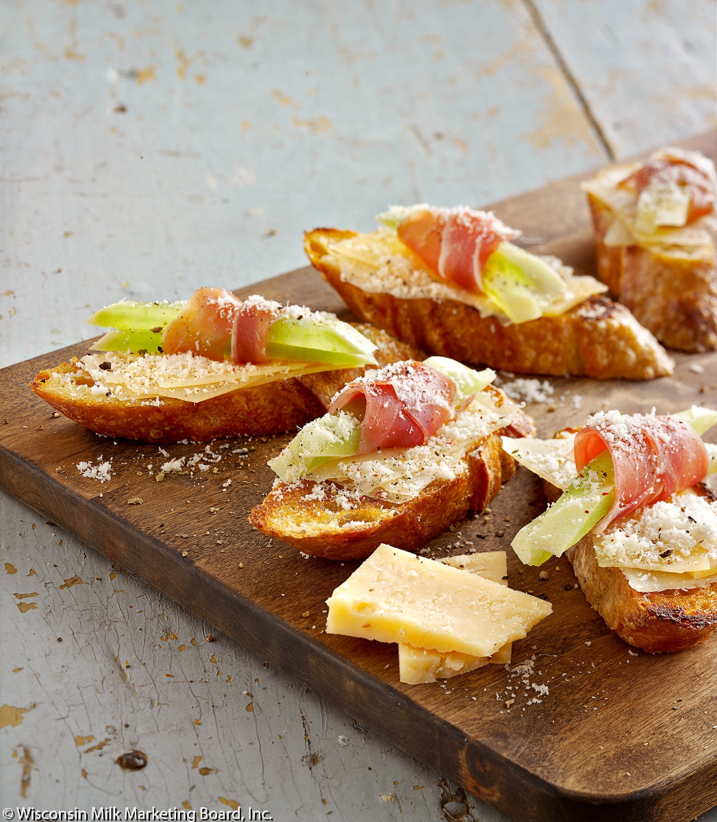 A block of aged Parmesan cheese with a granular texture, showcasing its rich, buttery color and perfect for grating or shaving.