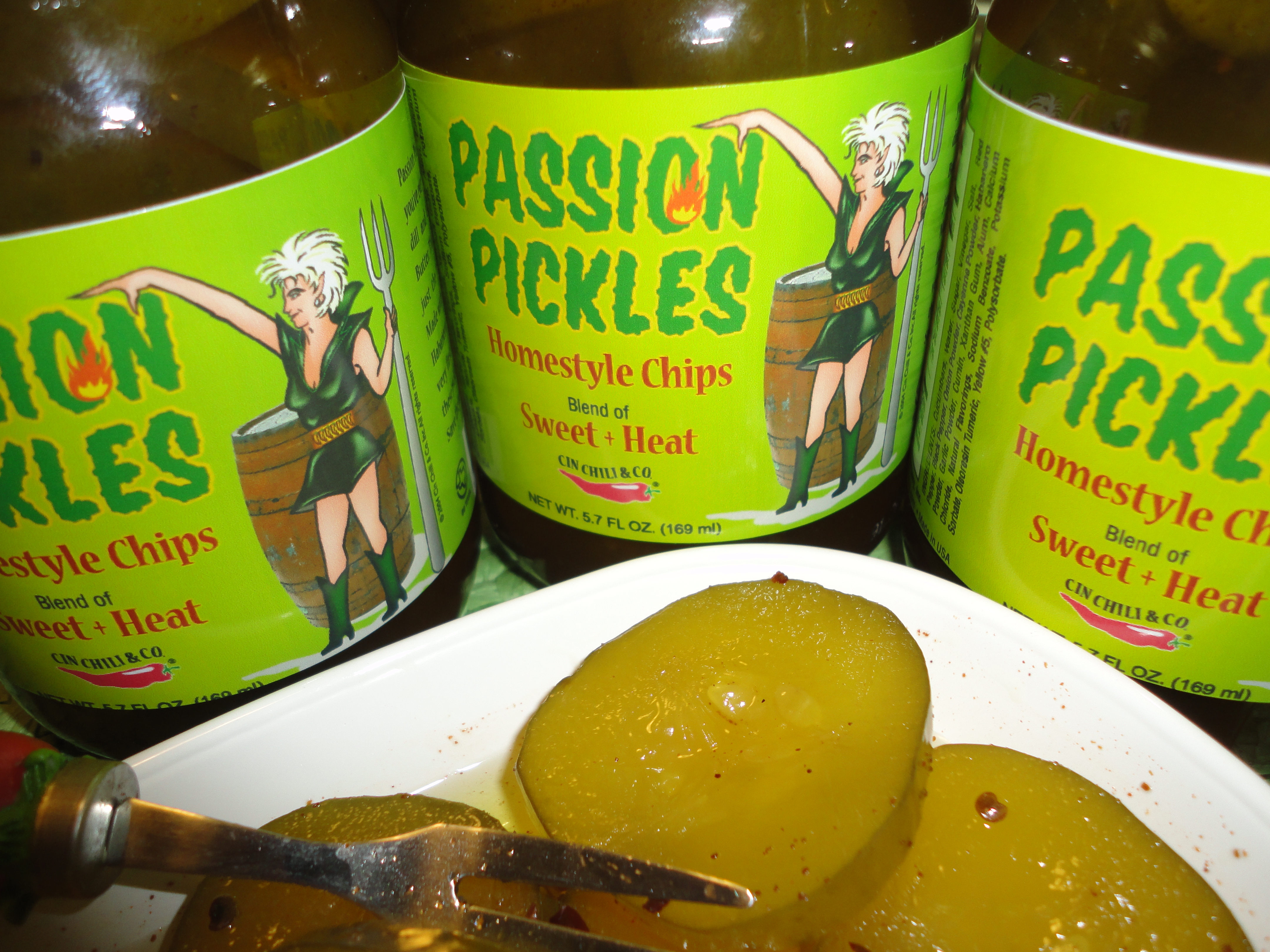 A jar of Passion Pickles® Habanero showcasing vibrant green cucumbers infused with a sweet and spicy habanero flavor.