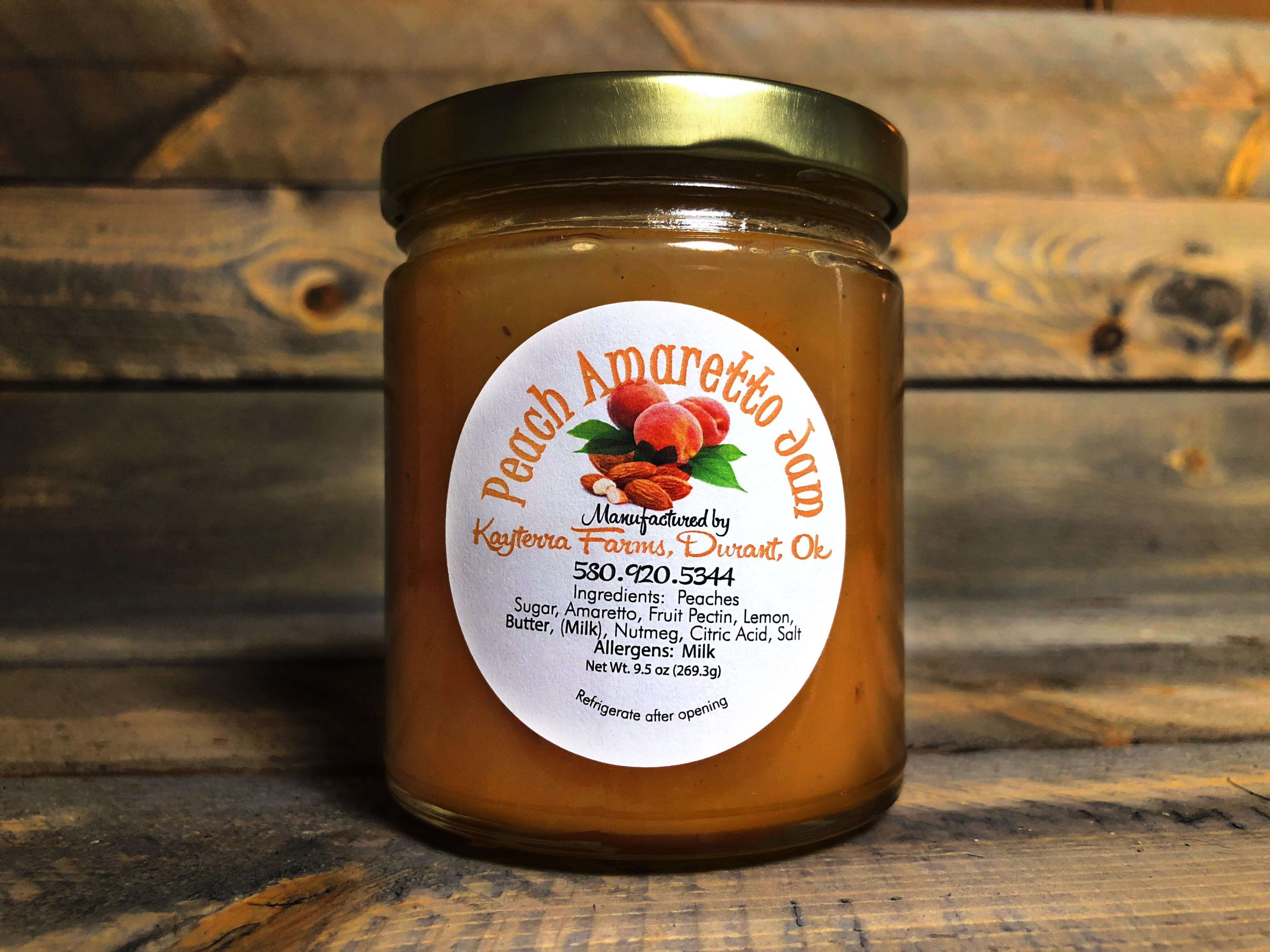 A jar of Peach Amaretto Jam showcasing golden peaches and almond flavor, perfect for spreading on bread or pancakes.