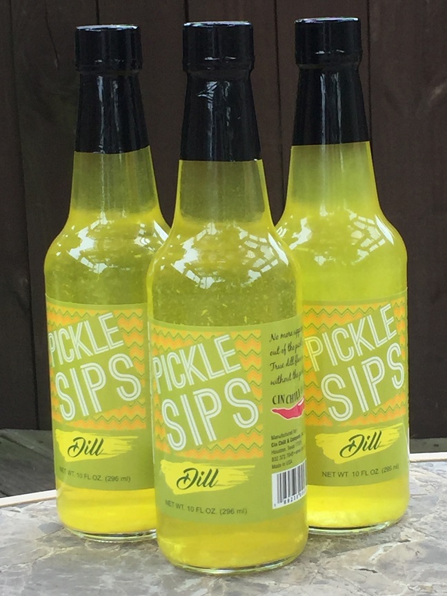 A 10 oz bottle of PICKLE SIPS™ Dill, showcasing its vibrant green color and label design.