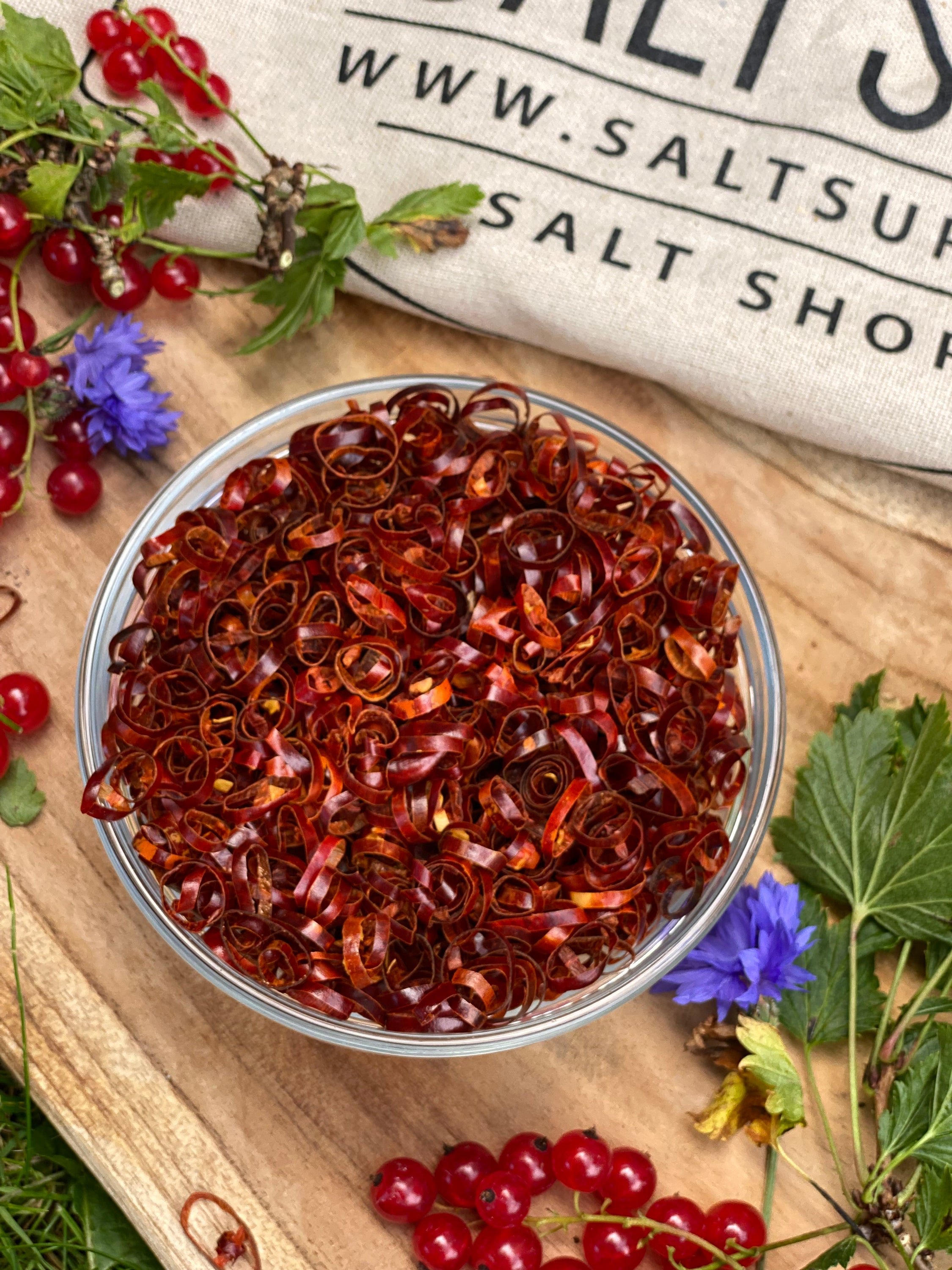 A jar of Red Chili Rings showcasing vibrant red dried chili pepper circles, perfect for cooking and garnishing.