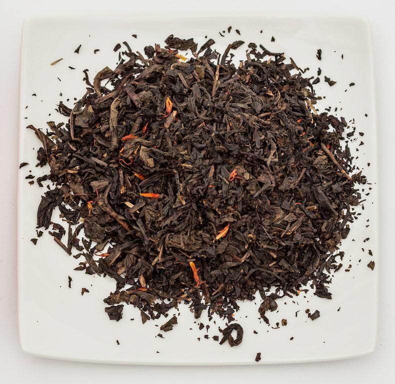 A vibrant package of Sassy Redhead Red Wine Infused Tea featuring a blend of black tea and berry flavors, showcasing its unique and enticing design.