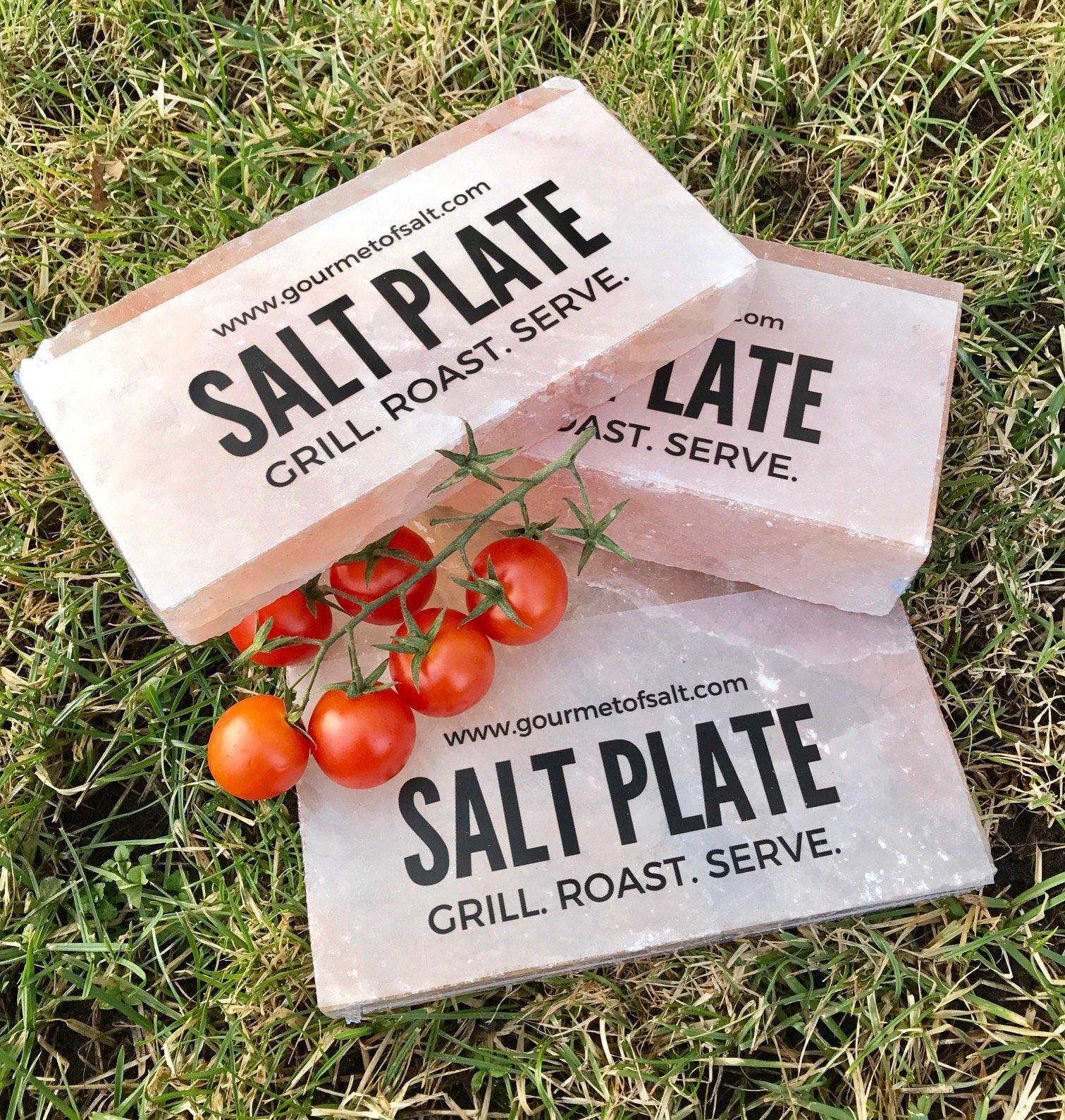 A small SALT PLATE made of Himalayan pink salt, perfect for grilling and serving various dishes, showcasing its unique natural patterns.