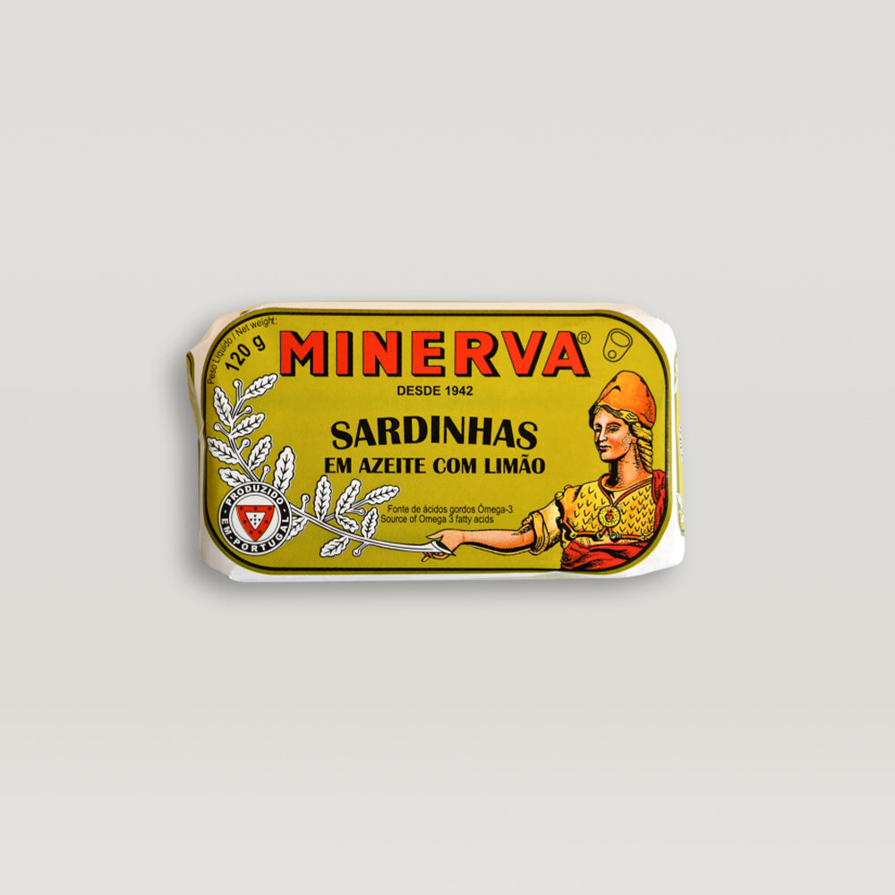 A can of sardines in olive oil with a slice of lemon, showcasing the rich texture and vibrant colors of the fish and oil.