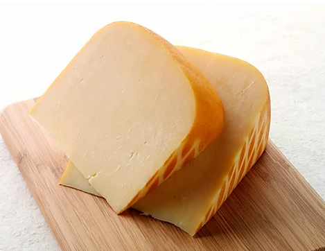 A block of Smoked Gouda cheese with a rich, smoky flavor, perfect for cheese boards and recipes.