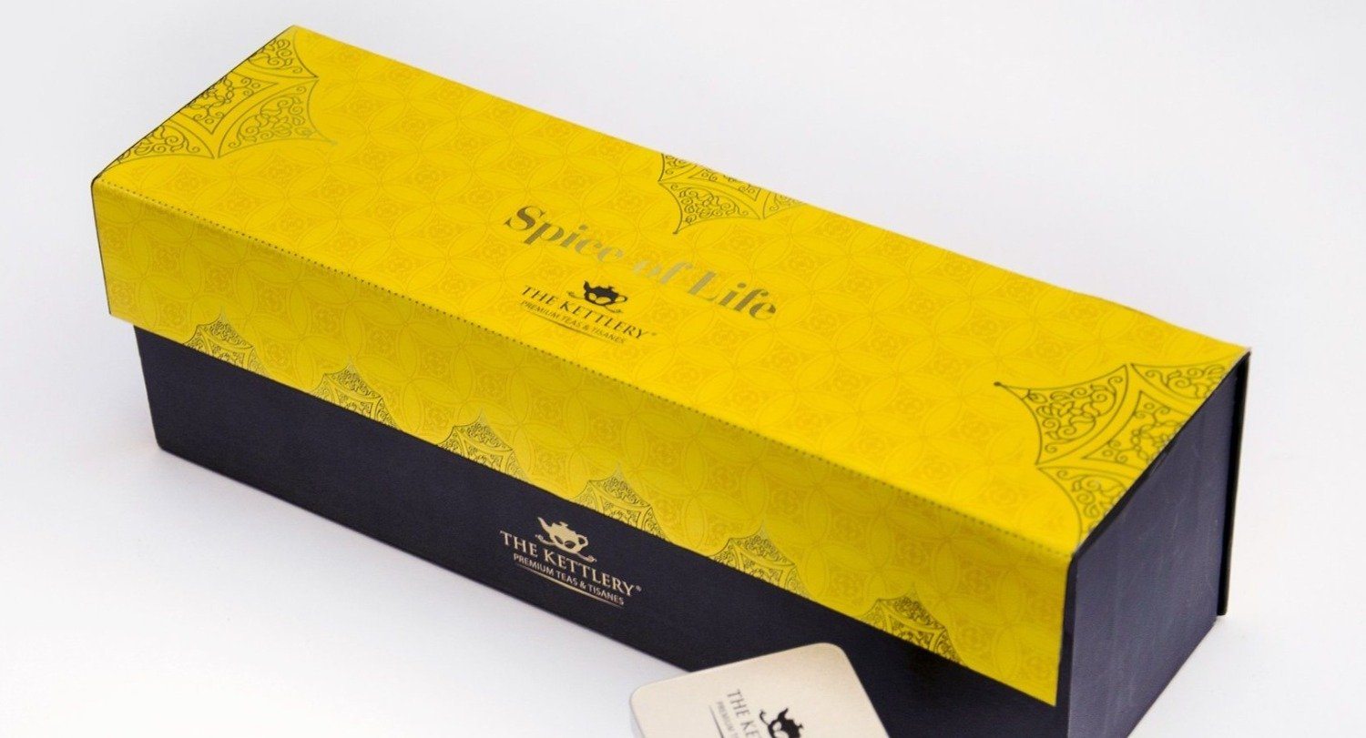 Spice of Life Tea Set featuring four unique spiced chai tea tins in a vibrant yellow box, perfect for gifting.