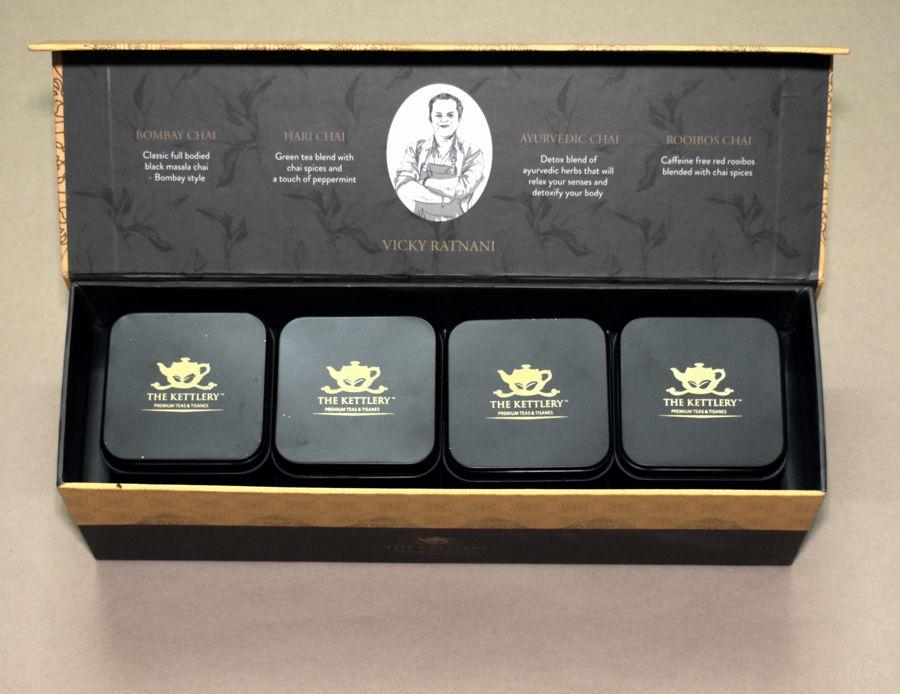 Spice of Life Tea Set featuring four unique spiced chai tea tins in a vibrant yellow box, perfect for gifting.