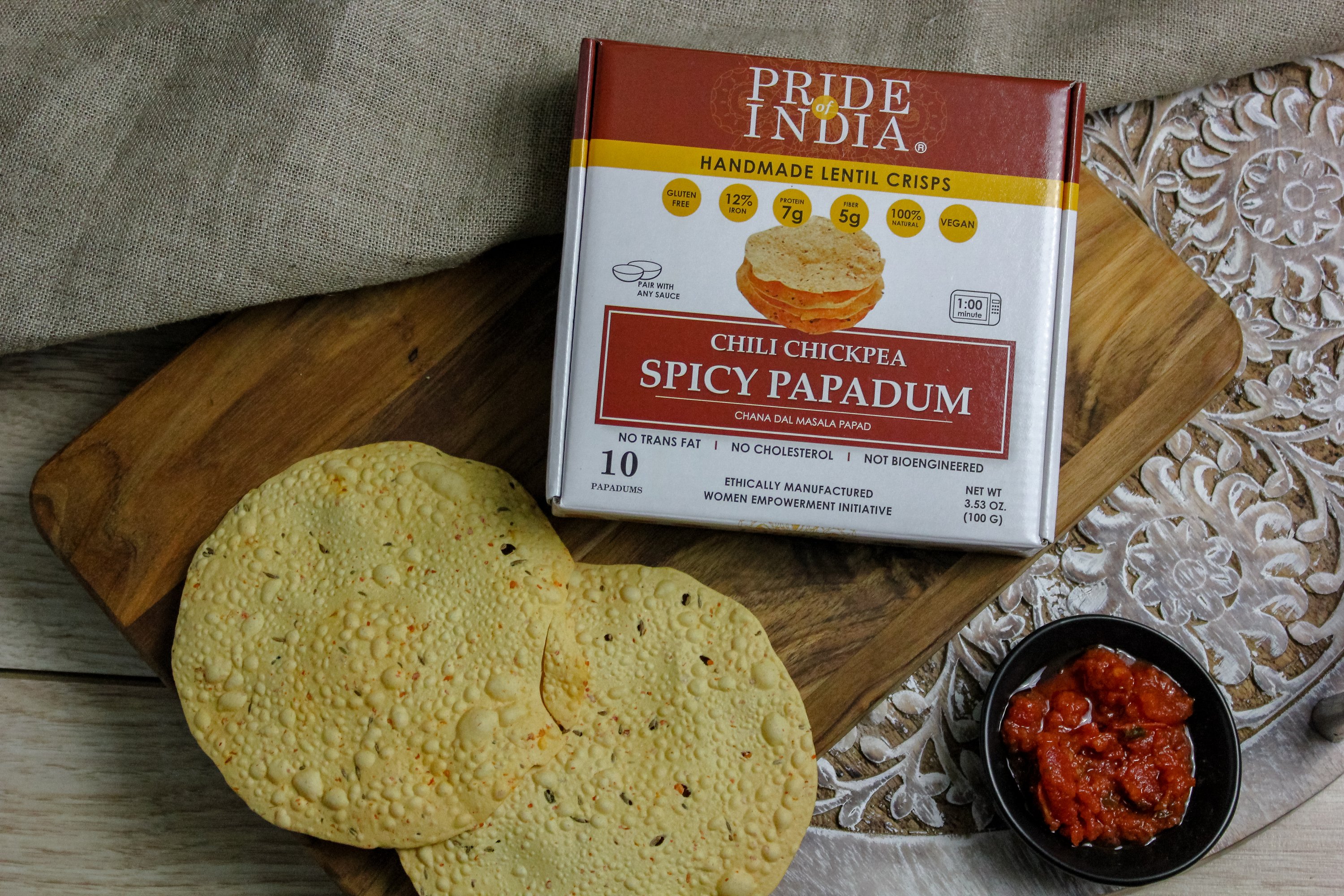 A pack of Spicy Chickpea Masala Papadum Lentil Crisp showcasing the crispy lentil snacks with vibrant spices.