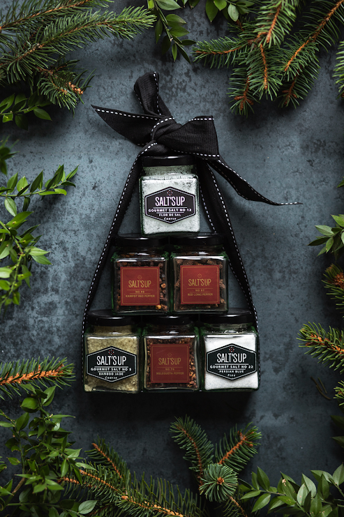 A beautifully arranged starter set of gourmet peppers in glass jars, showcasing various colors and textures, perfect for culinary enthusiasts.