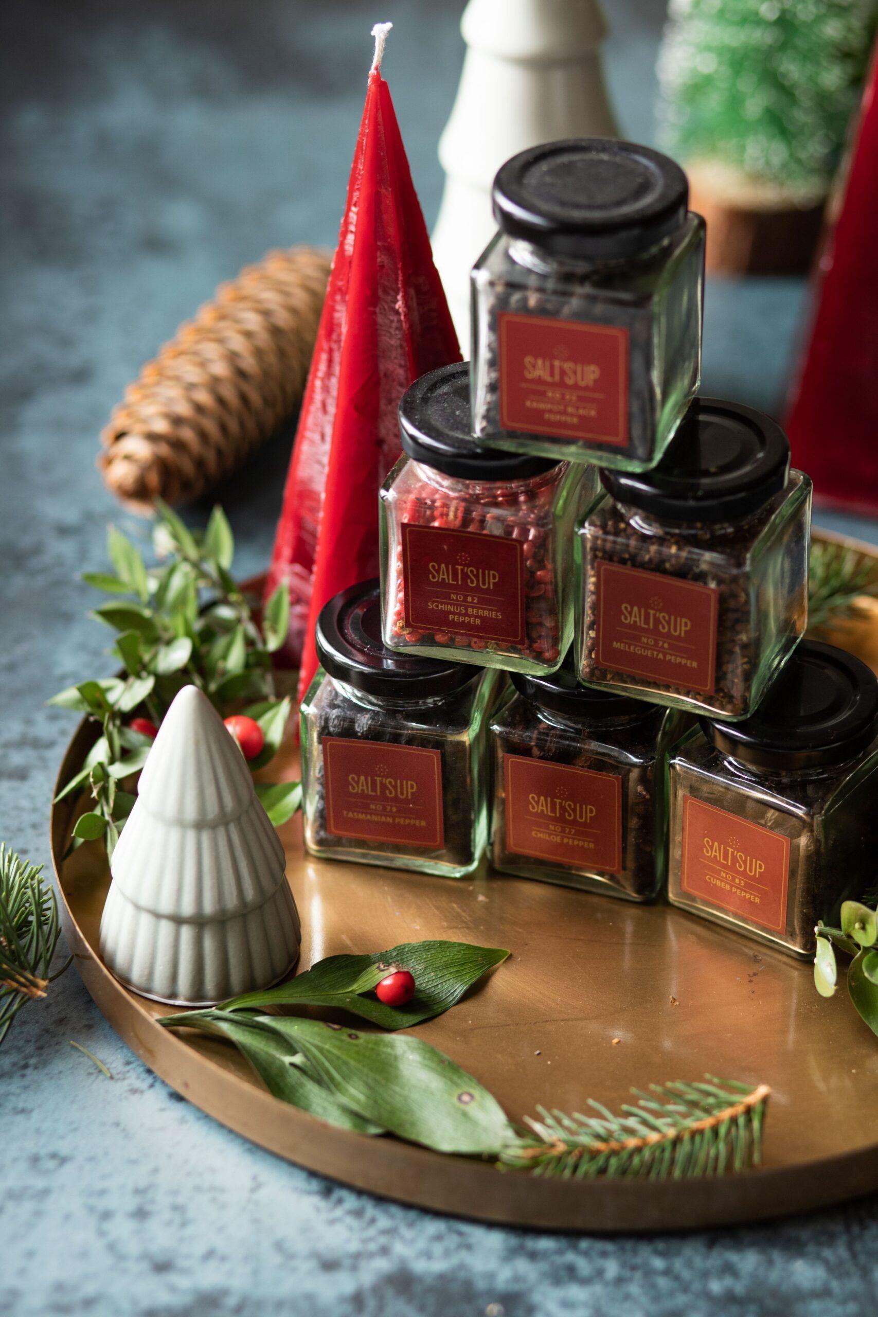 A beautifully arranged starter set of gourmet peppers in glass jars, showcasing various colors and textures, perfect for culinary enthusiasts.