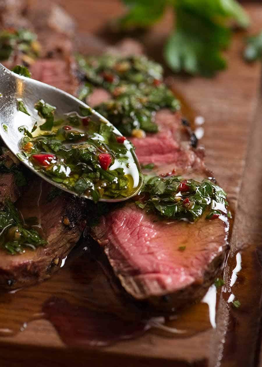 A bottle of fresh and zingy steak sauce with herbs and spices, perfect for enhancing steak dishes.