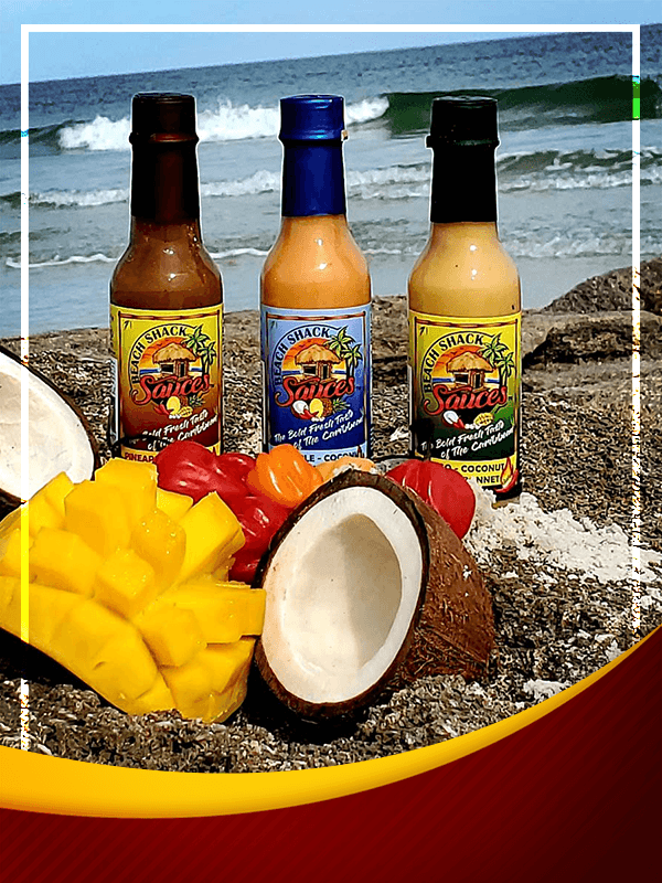 A vibrant bottle of Sweet Heat of the Caribbean hot sauce featuring tropical mango and coconut flavors, perfect for enhancing dishes.