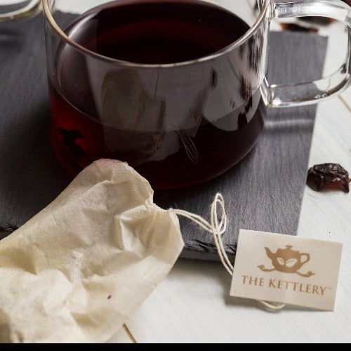 A pack of 100 Kettlery tea bags made from biodegradable wood pulp, ideal for loose leaf tea brewing.