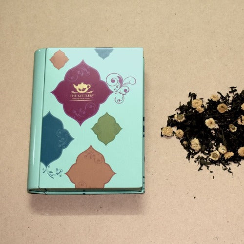 A beautifully designed tea book tin containing a selection of premium teas, perfect for gifting.