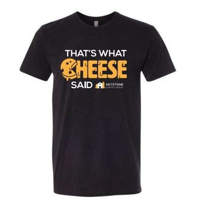 A black t-shirt featuring the humorous phrase 'That's What Cheese Said' in a playful font, available in various colors.