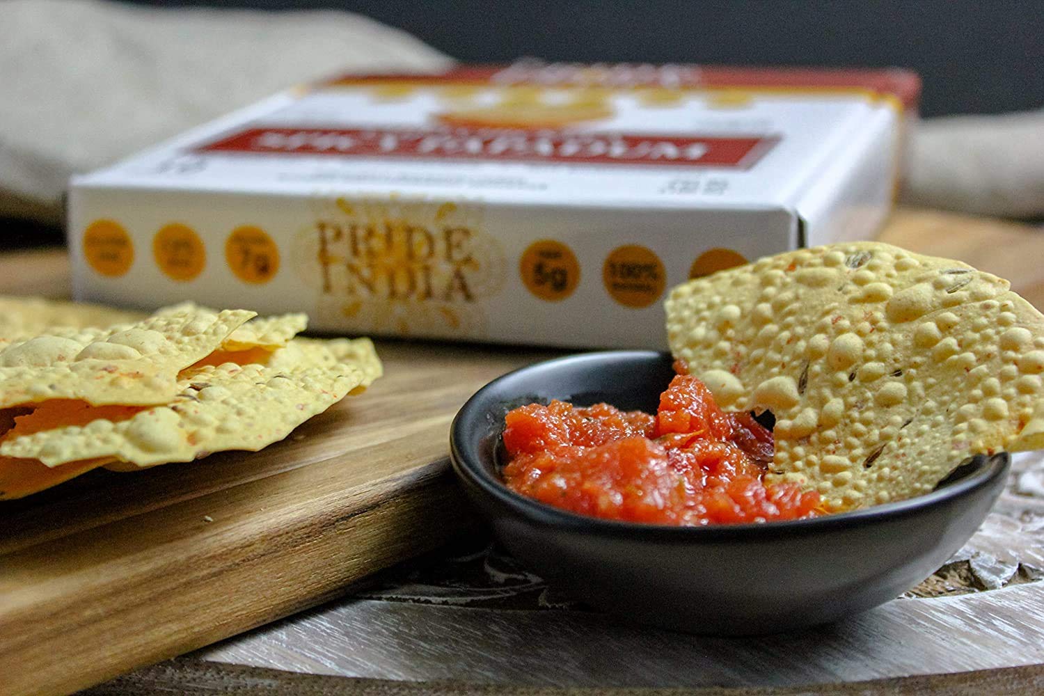 A pack of Tikka Curry Mung Bean Papadum, showcasing the lentil crisps with vibrant colors and textures, ideal for snacking or appetizers.