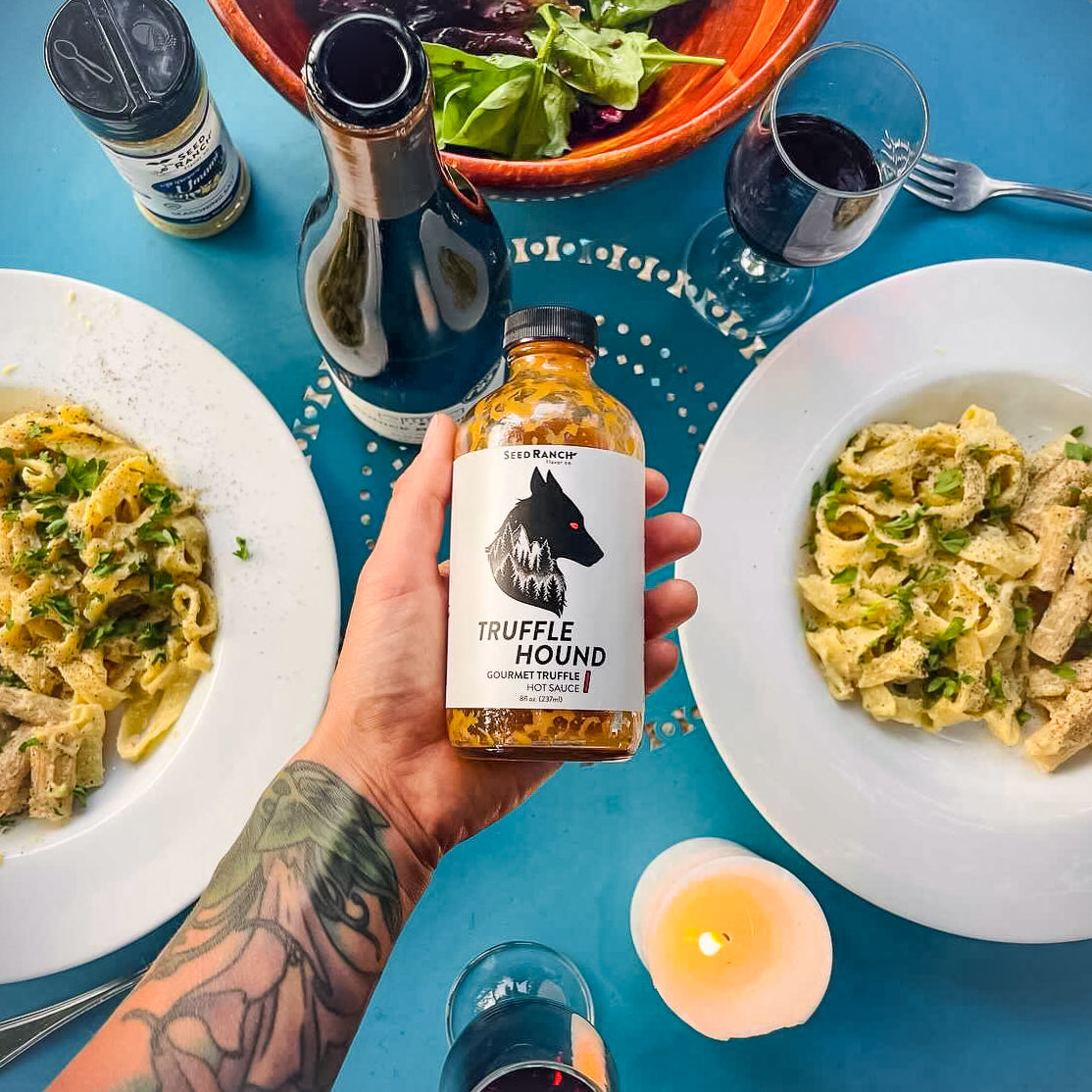 A bottle of Truffle Hound gourmet hot sauce featuring real summer truffles and organic chili peppers, elegantly designed for culinary enthusiasts.