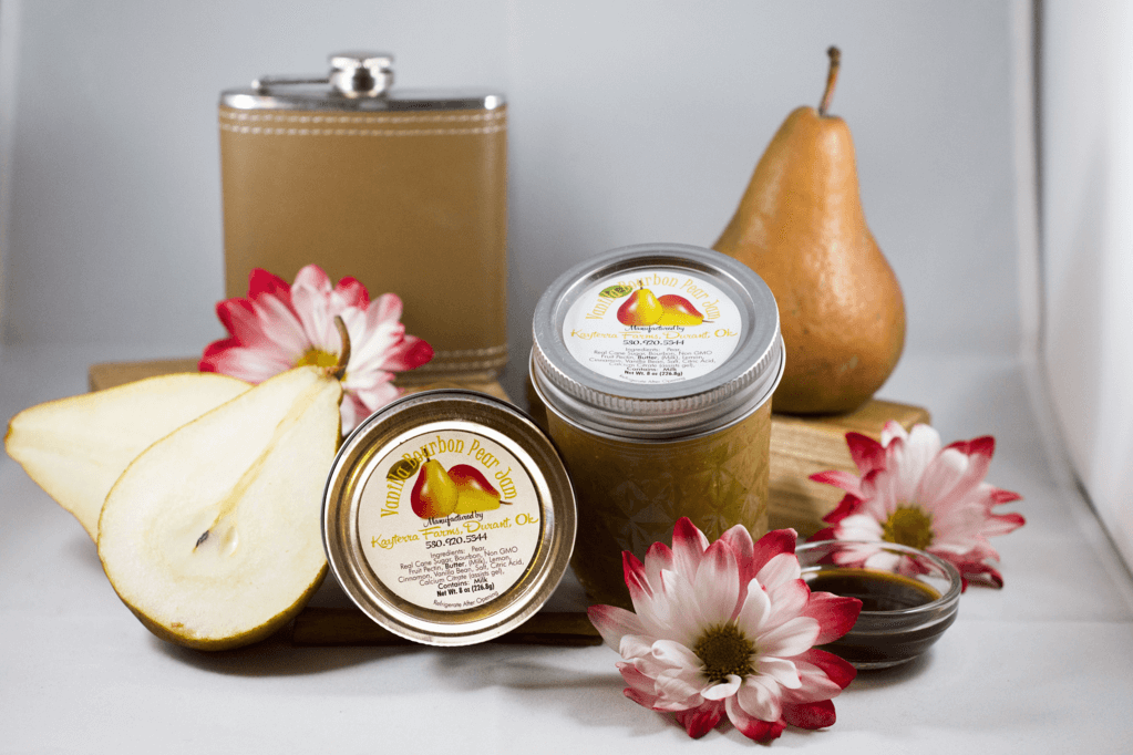 A jar of Vanilla Bourbon Pear jam showcasing its rich, golden color and ingredients like pears and vanilla bean.