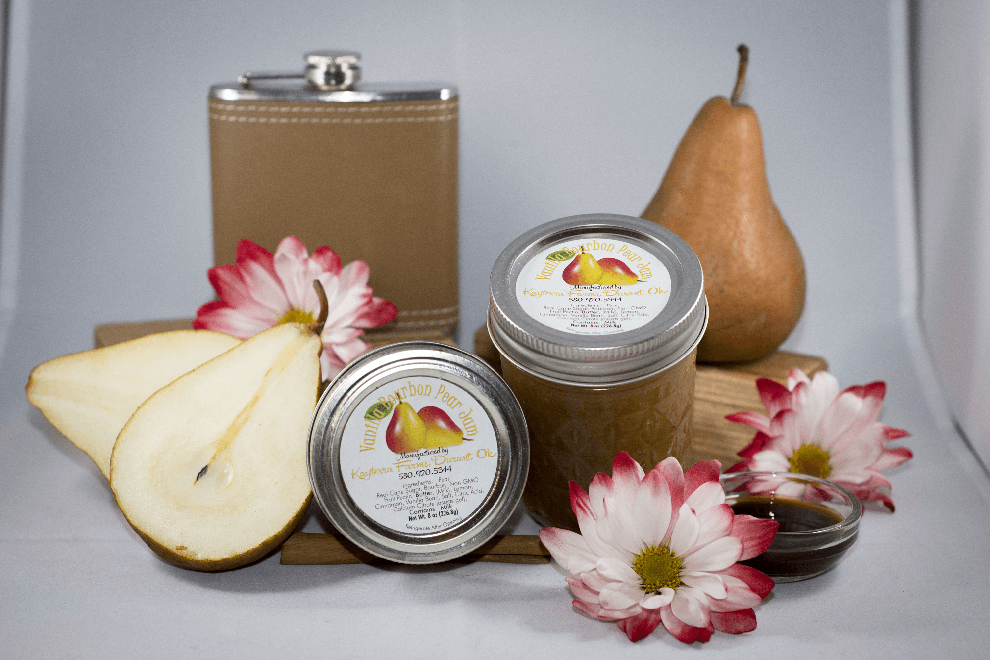 A jar of Vanilla Bourbon Pear jam showcasing its rich, golden color and ingredients like pears and vanilla bean.