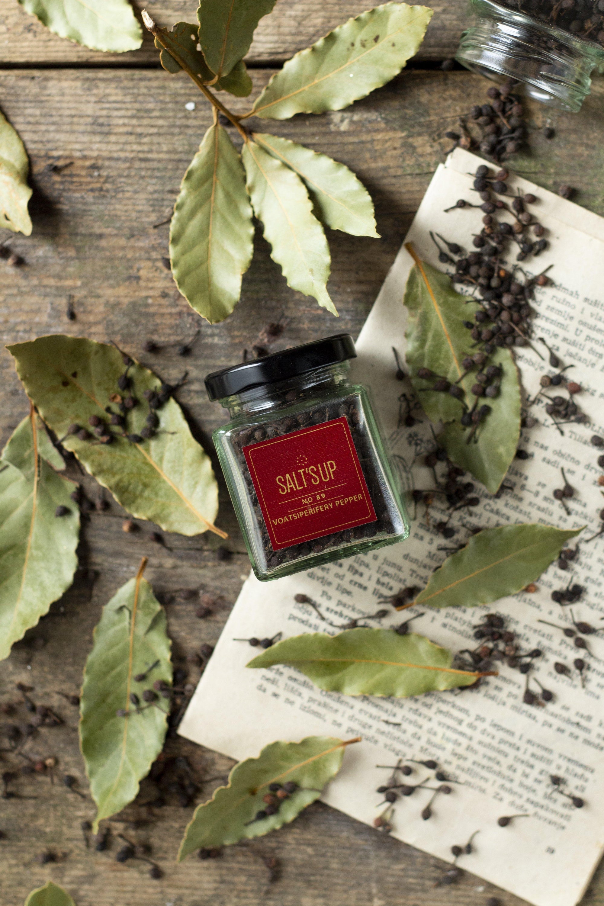 A glass jar of VOATSIPERIFERY pepper showcasing its unique wild cubeb from Madagascar, with a rich aroma and distinctive flavor.