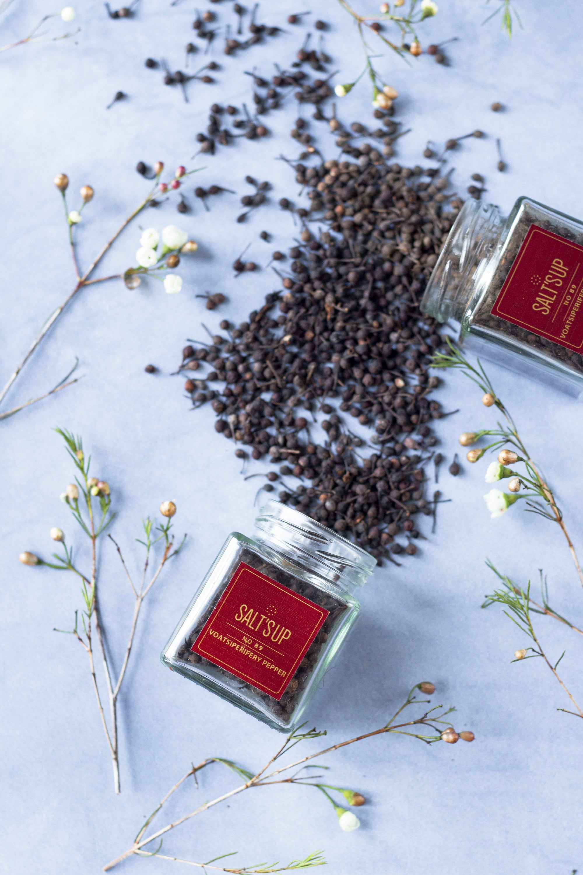 A glass jar of VOATSIPERIFERY pepper showcasing its unique wild cubeb from Madagascar, with a rich aroma and distinctive flavor.