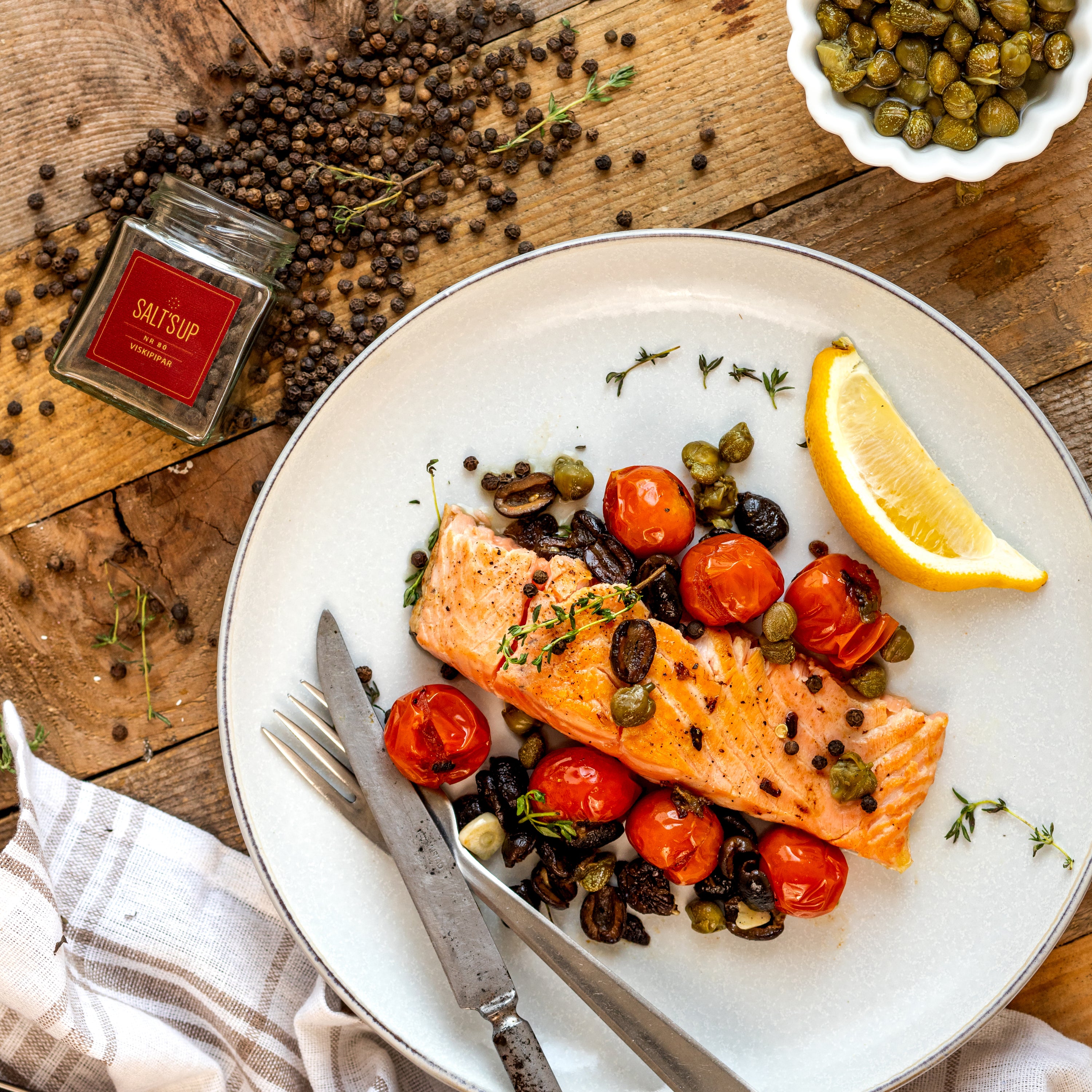 A glass jar of Whiskey Pepper seasoning, showcasing its rich blend of spices and whiskey flavor, perfect for enhancing meats.