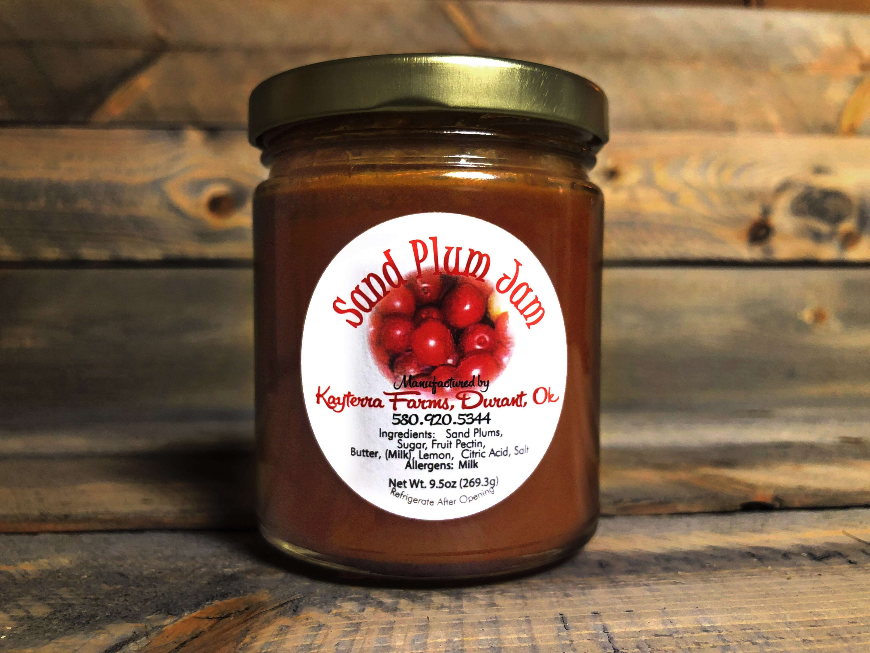 A jar of Wild Sand Plum Jam showcasing its rich, sweet, and tangy texture, perfect for spreading on toast or muffins.