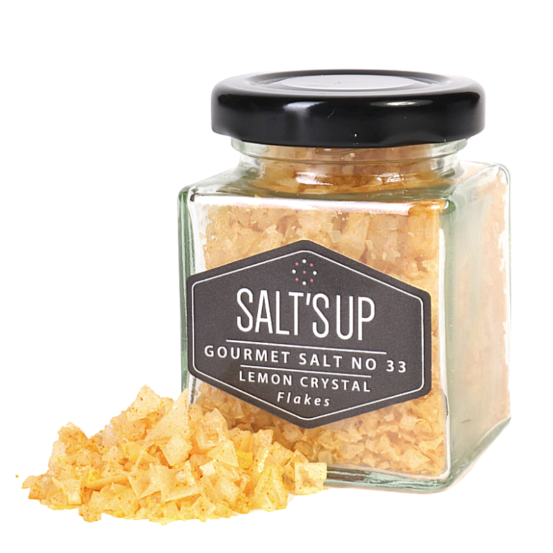 Bright yellow pyramid-shaped salt flakes infused with lemon extract, ideal for garnishing dishes.