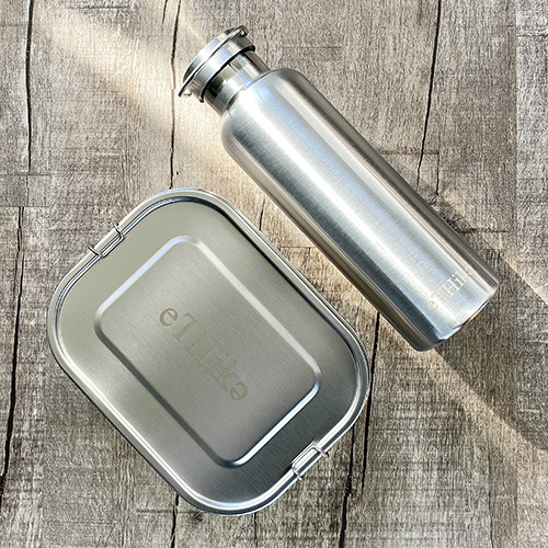 Zero Waste Starter Kit featuring a stainless steel lunchbox and water bottle, designed for eco-friendly meals and drinks.