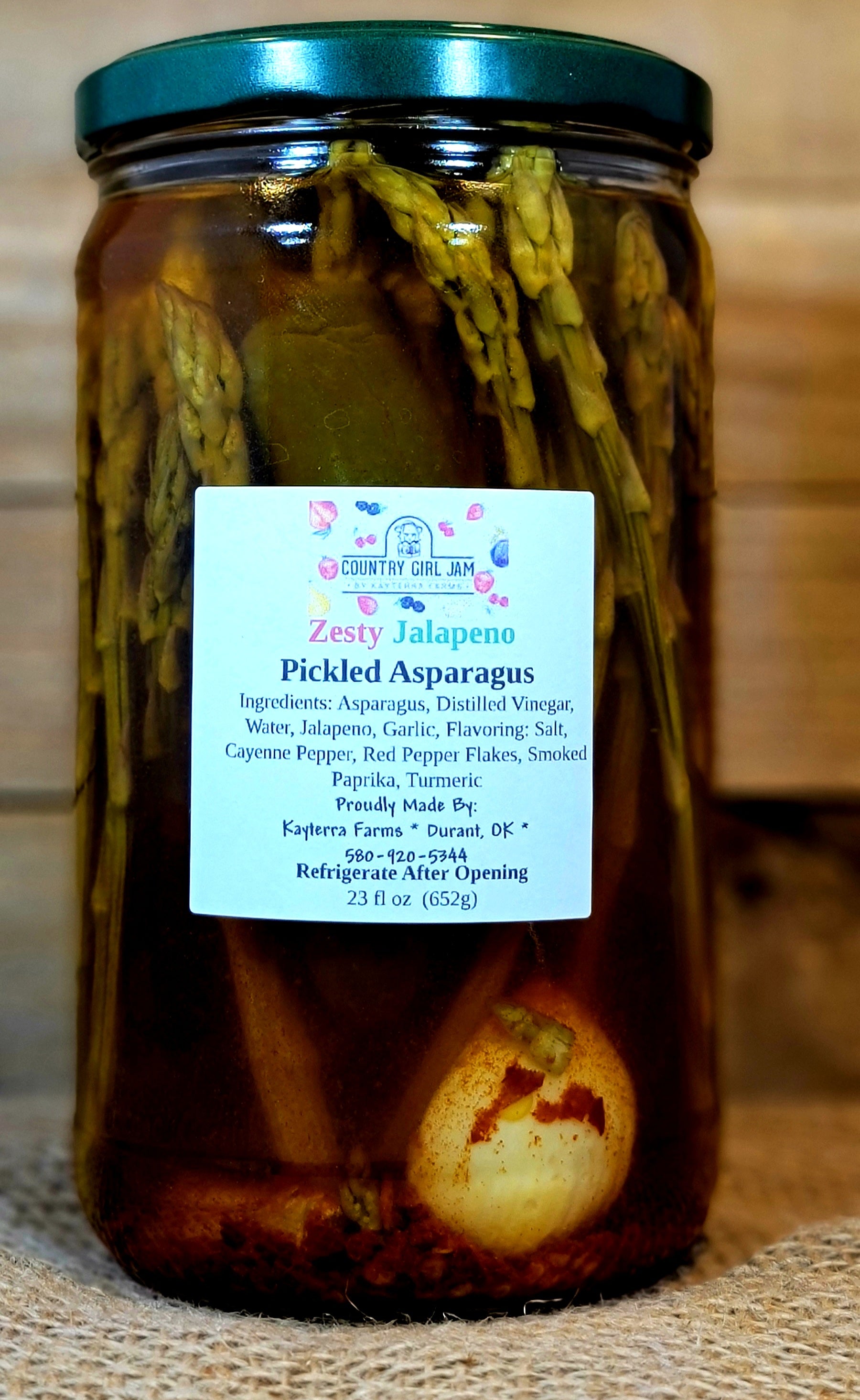 A jar of Zesty Jalapeno Pickled Asparagus with vibrant green spears and jalapeno slices, showcasing its spicy and savory appeal.