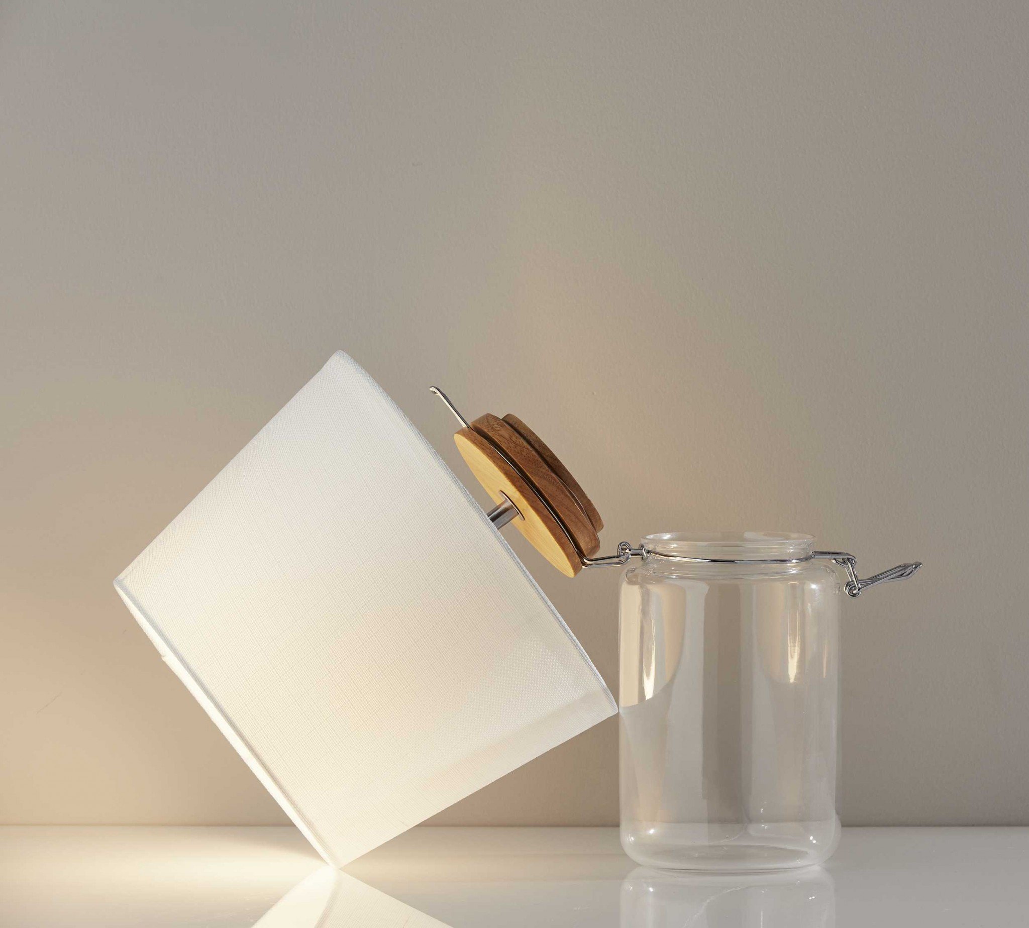 A stylish 10" x 10" x 16" clear jar table lamp featuring a vintage mason jar design with a natural wood top and metal latch lid.