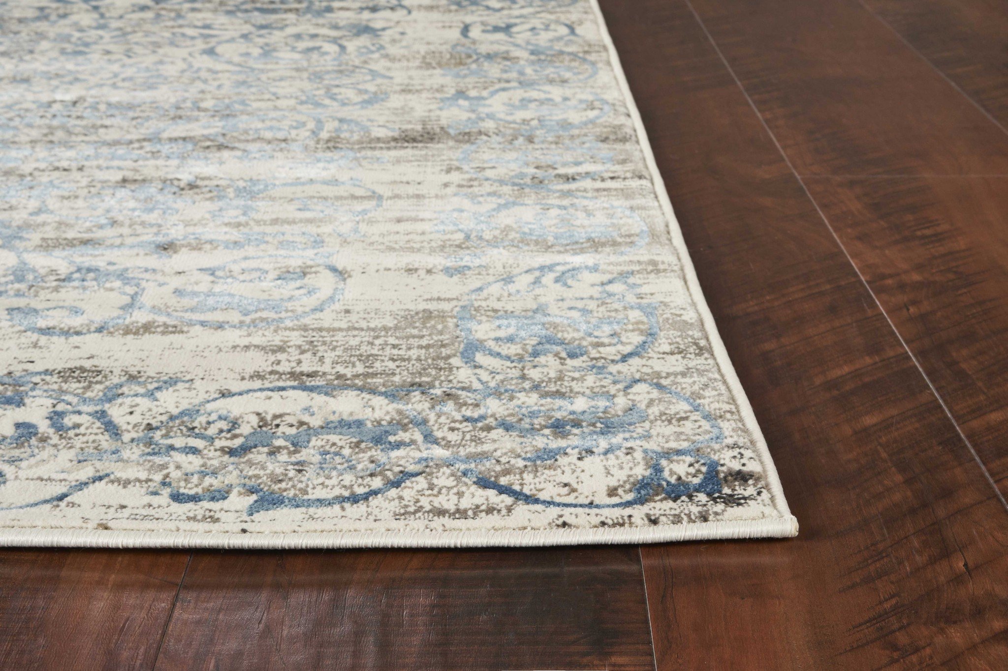 108" x 156" Ivory Polypropylene Rug with vintage patterns, showcasing plush texture and elegant design.