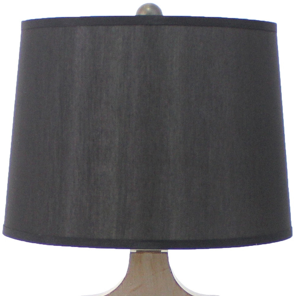 A traditional wooden table lamp featuring a black linen shade, elegantly designed to enhance home decor.