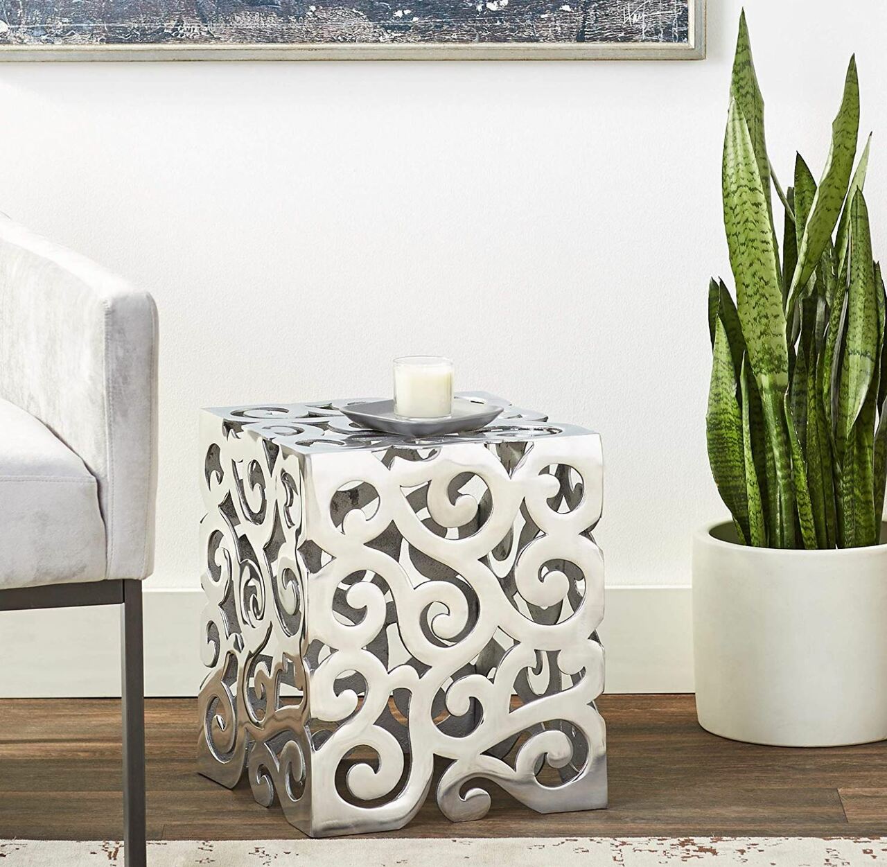 A stylish 12x12x17 buffed paisley square stool made of aluminum, featuring an intricate paisley design, perfect for modern decor.