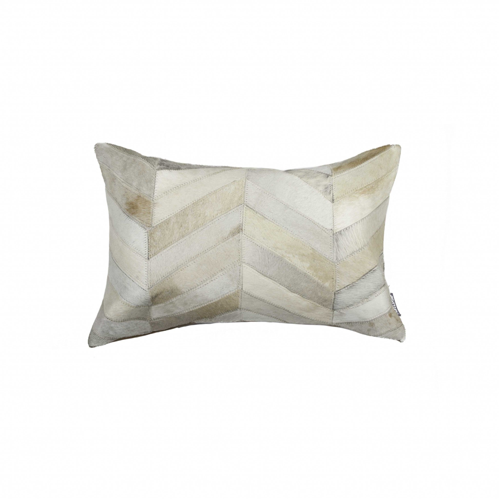 A luxurious 12x20 natural pillow made from Indian cowhide with a soft microsuede backing, featuring a concealed zipper closure.