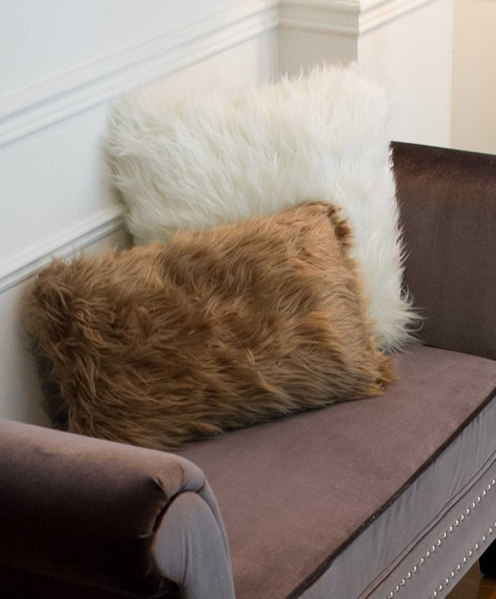 Two luxurious tan faux fur pillows, 12x20 inches, showcasing plush texture and elegant design, perfect for home decor.