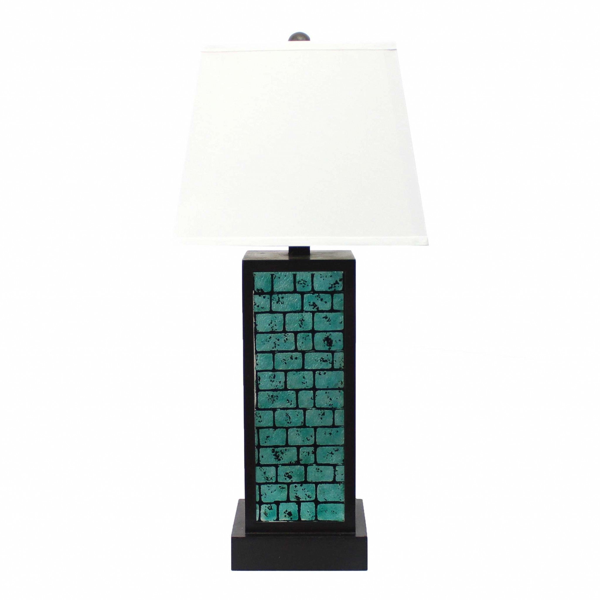 A contemporary teal brick pattern table lamp with a white linen shade, showcasing a stylish metal base.