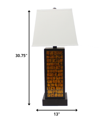 A contemporary black metal table lamp featuring a vibrant yellow brick pattern base and a white linen shade, perfect for modern home decor.