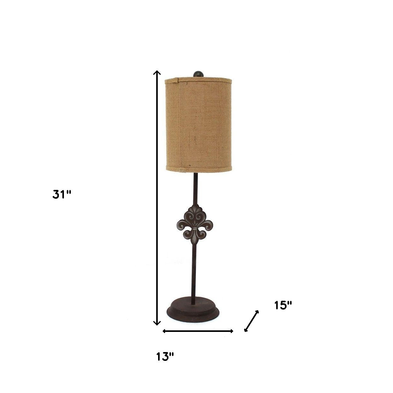 A bronze traditional table lamp featuring a fleur-de-lis metal base and a round khaki linen shade, standing 31 inches tall.