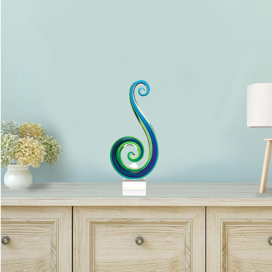 A stunning 14 mouth blown art glass centerpiece in blue and green colors, elegantly displayed on a base, showcasing its unique craftsmanship.