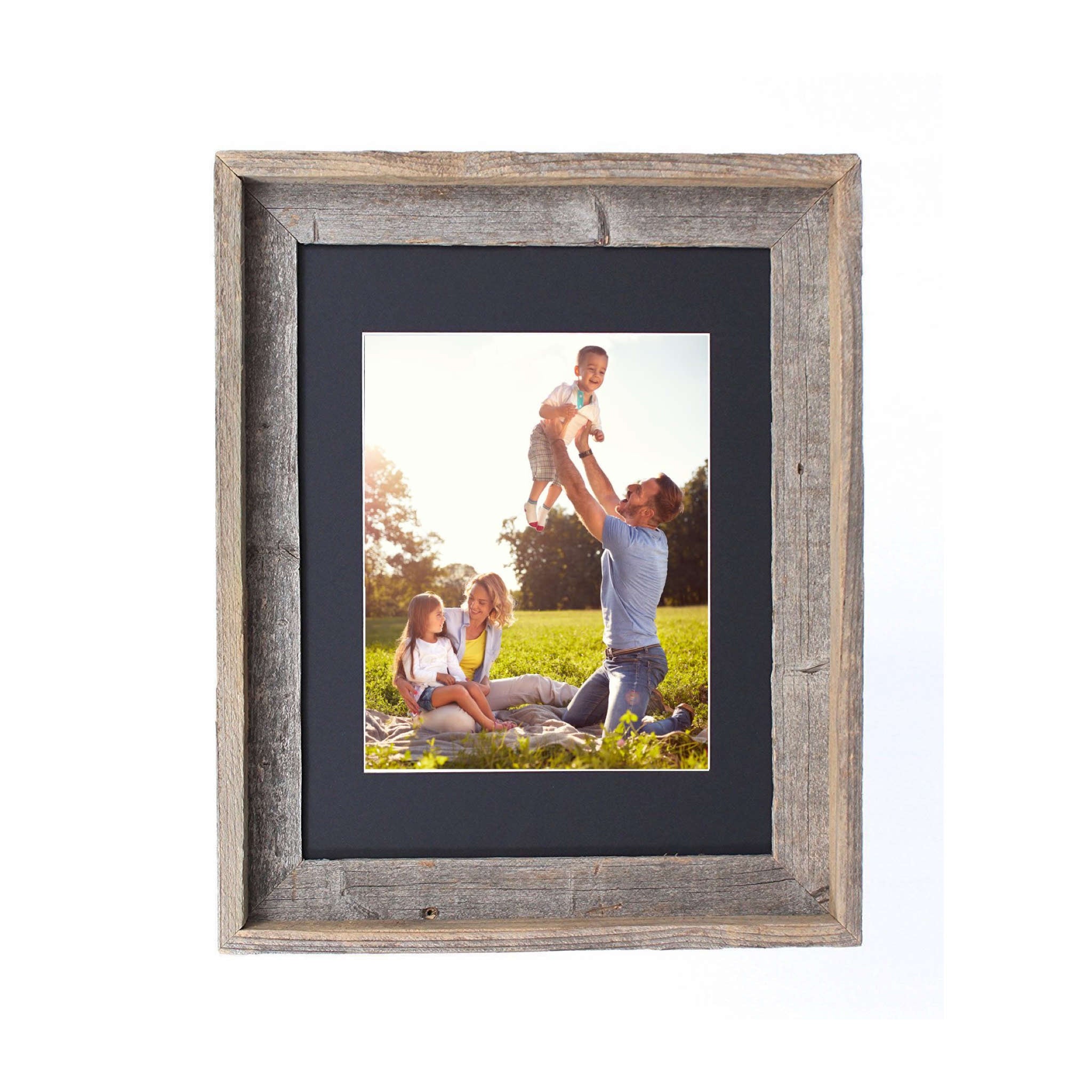 A rustic black picture frame measuring 16x20 inches, made from reclaimed wood with a plexiglass holder, showcasing a beautiful photo.