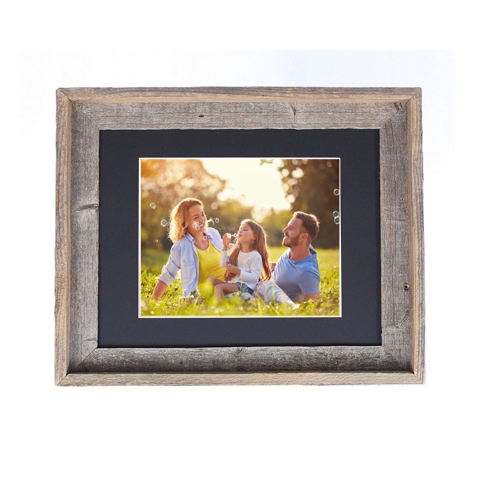 A rustic black picture frame measuring 16x20 inches, made from reclaimed wood with a plexiglass holder, showcasing a beautiful photo.