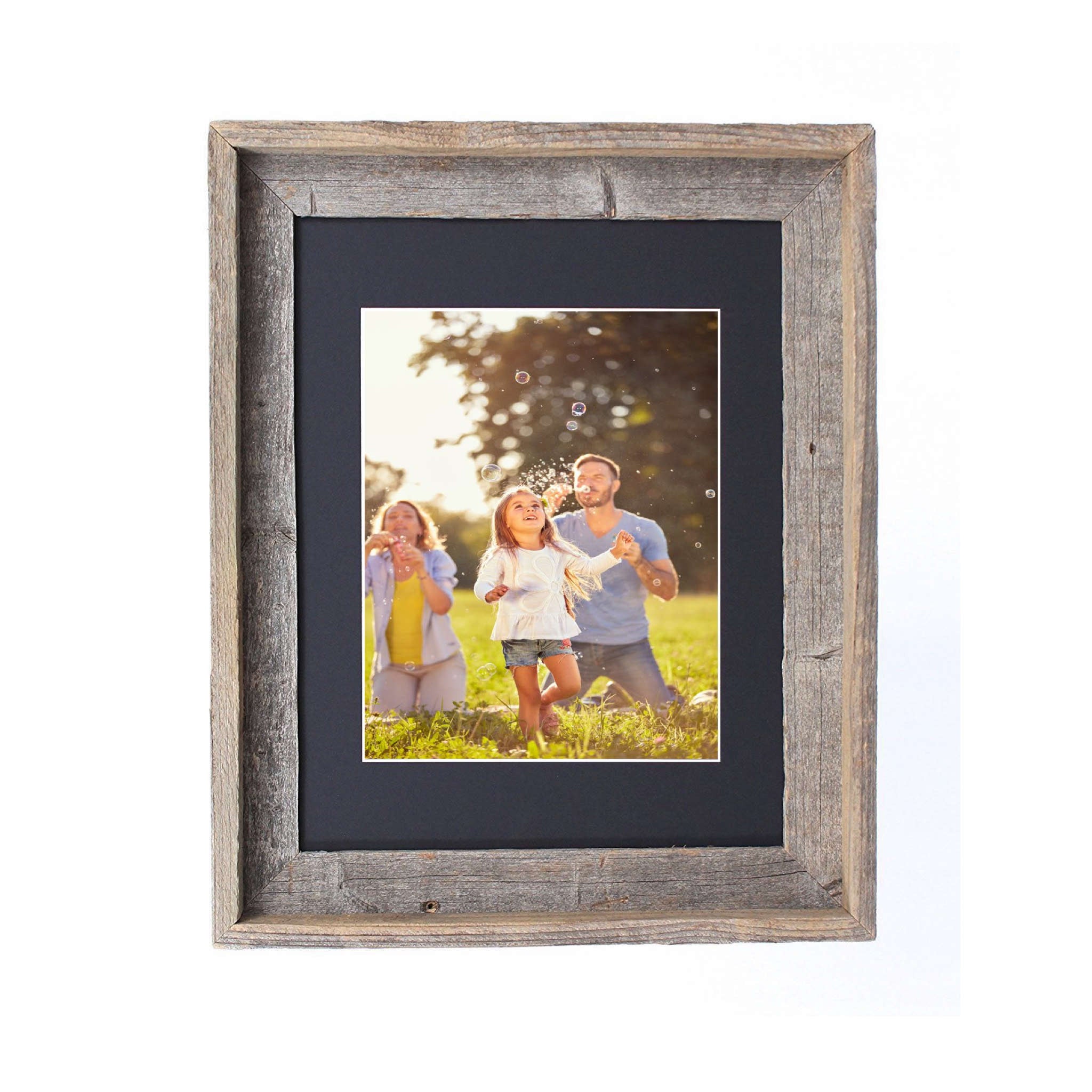 A rustic black picture frame measuring 16x20 inches, made from reclaimed wood with a plexiglass holder, showcasing a beautiful photo.