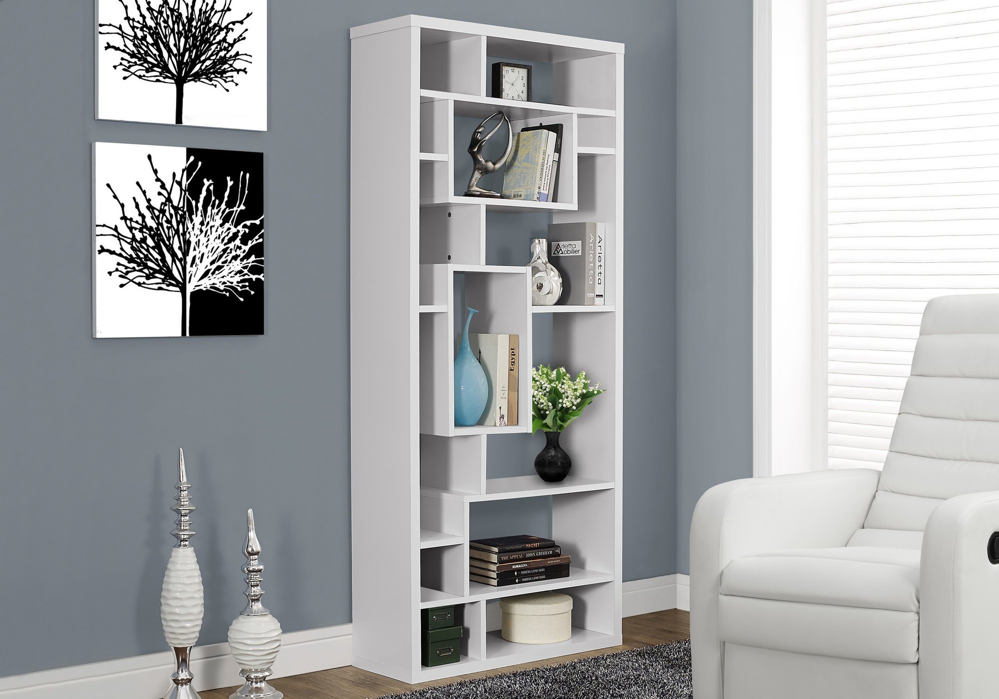 A stylish white particle board bookcase with 14 asymmetrical shelves, designed for modern living spaces.